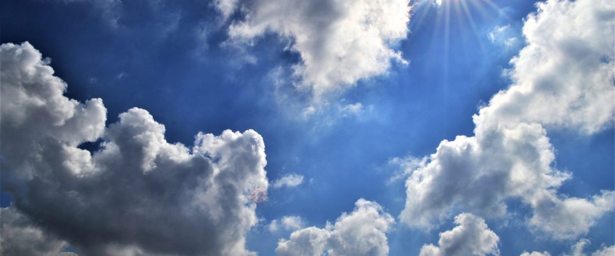 white-fluffy-clouds-against-a-blue-sky-and-the-sun-2021-08-30-13-24-59-utc